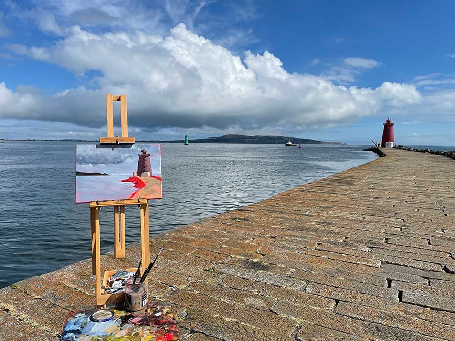 Painting in progress on easel on location at poolbeg Lighthouse Dublin.